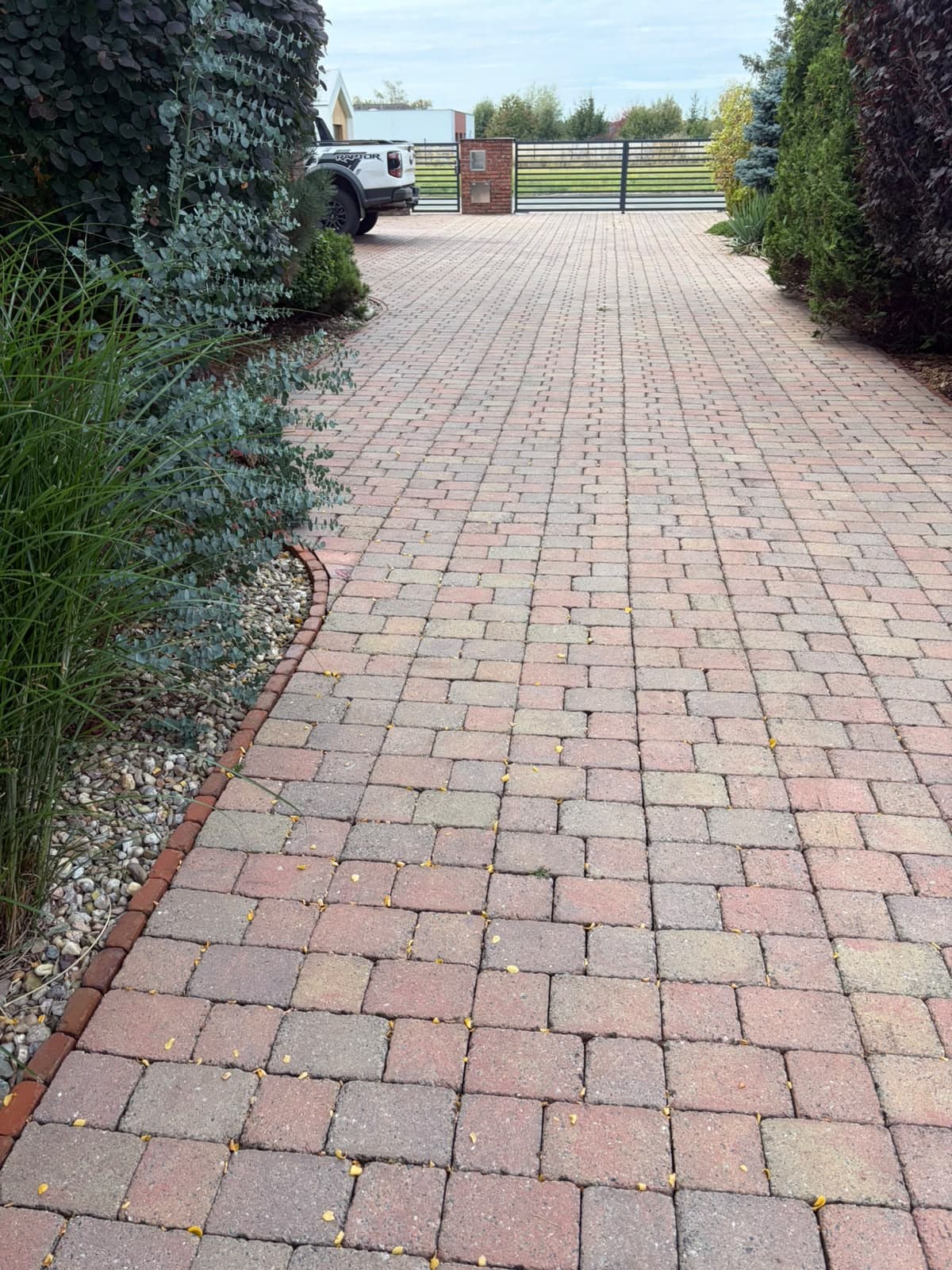 The same driveway after cleaning — the paving back to its original colour